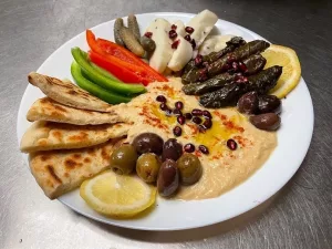 Mezze platter: Hummus, Stuffed grape leaves, Cheese, Veggies, Flatbread