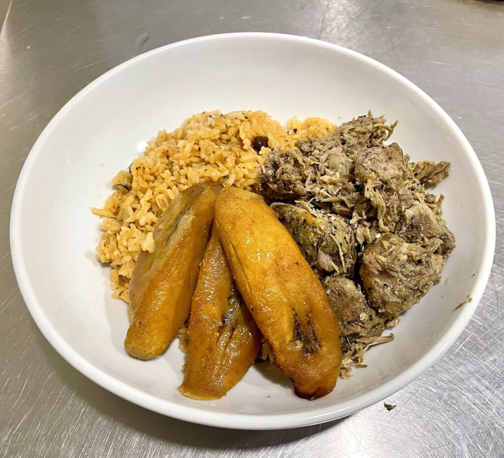 Pernil (roast pork), yellow rice, and sweet plantains