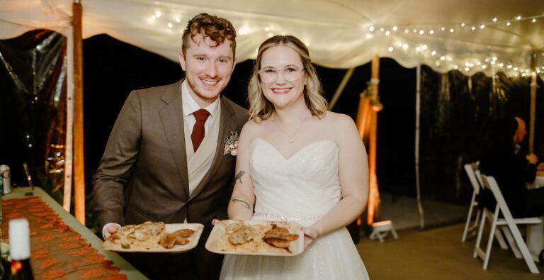 Upohar catering bride and groom holding their plates